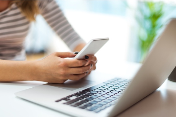 A woman using desktop and mobile device