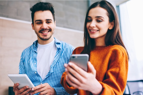 Two users with tablet and mobile device