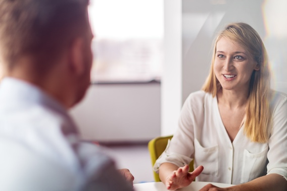 A woman discussing Machine Learning solutions with a client