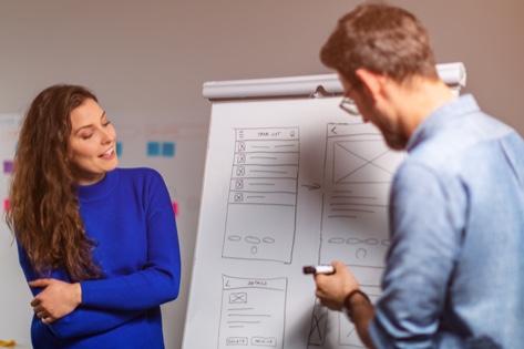 Two designers explaining tasks during workshops