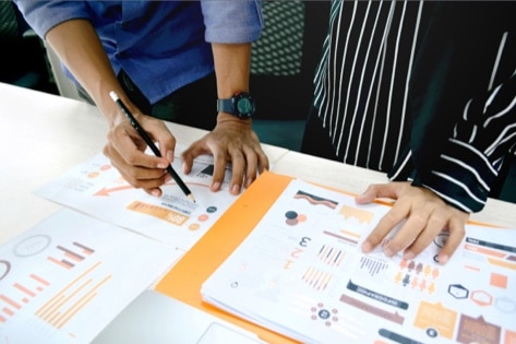 Two experts performing market analysis