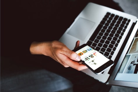 A user with mobile device and computer