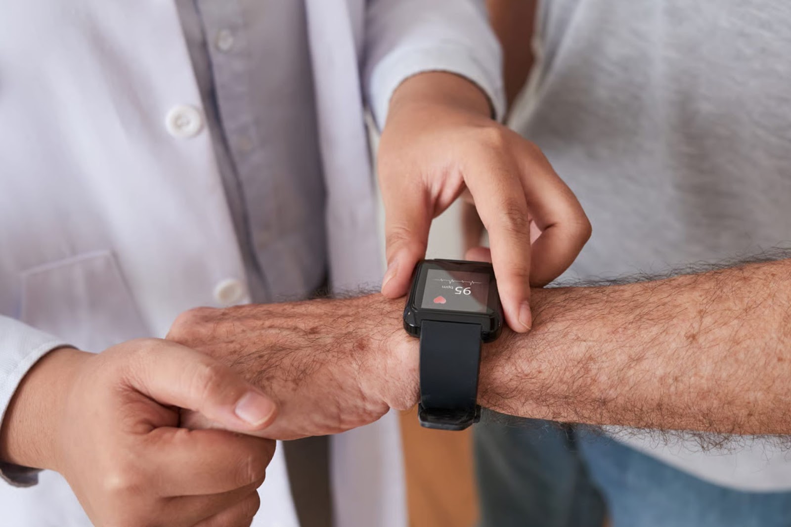 A healthcare provider checking a heart rate on a patient's smartwatch.