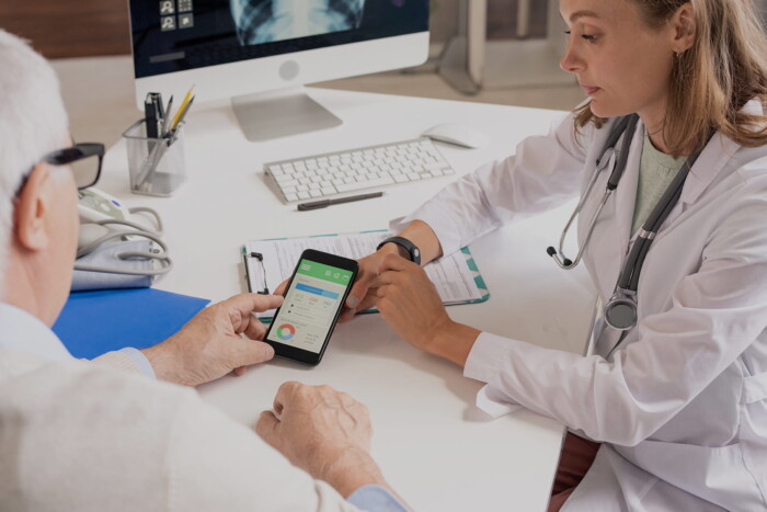 img doctor consulting senior patient with digital heal (1)