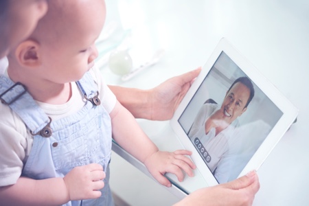 Mother with a child using telehealth solutions