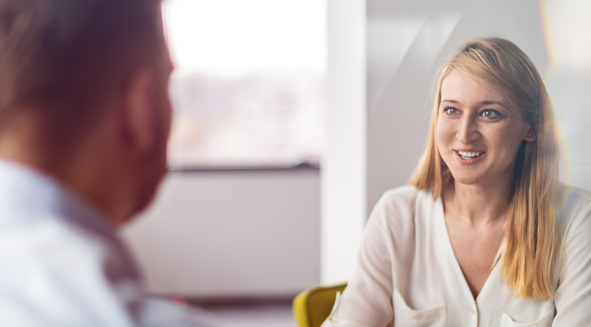 A woman discussing with a client about Node.js development solutions